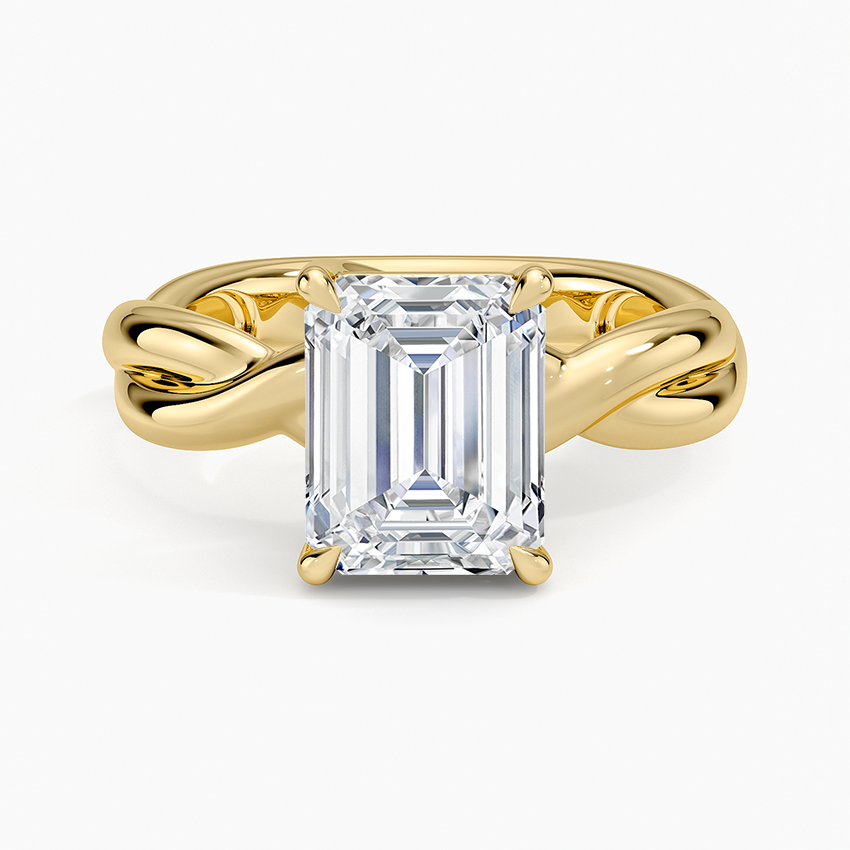 Emerald cut lab grown diamond ring on a plain twisted yellow gold rope band, top view