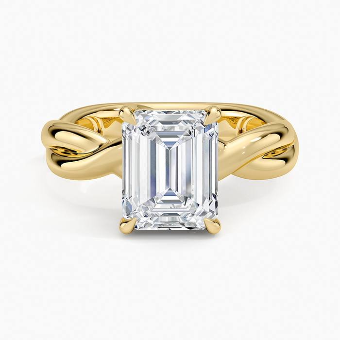Emerald cut lab grown diamond ring on a plain twisted yellow gold rope band, top view