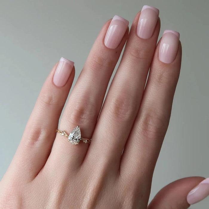 Pear cut lab grown diamond three stone ring with pear side stones, hand view