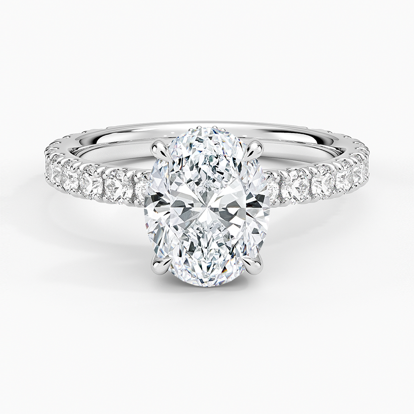 Oval cut lab grown diamond ring with a hidden halo on a fishtail pave eternity band in white gold, top view