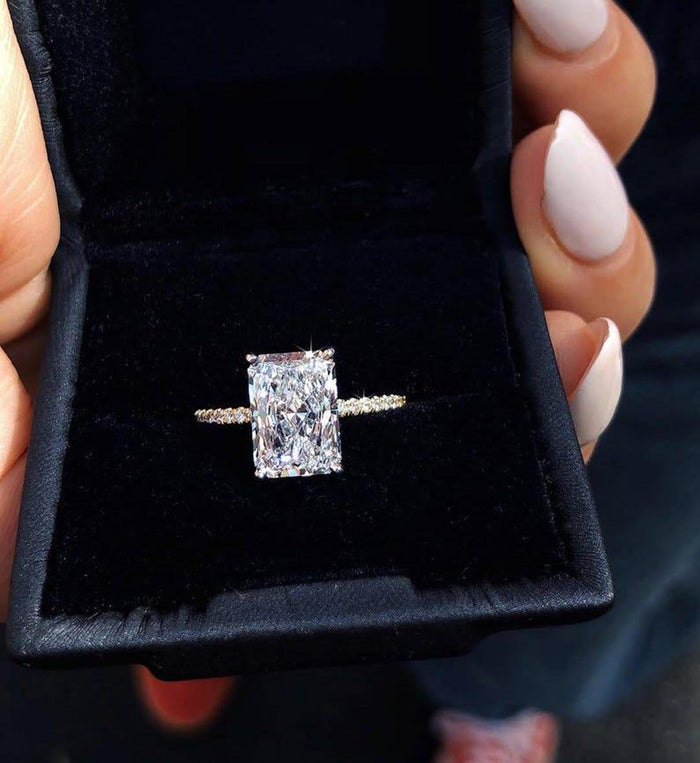 Hidden halo beneath the radiant cut centre stone with pave shoulders