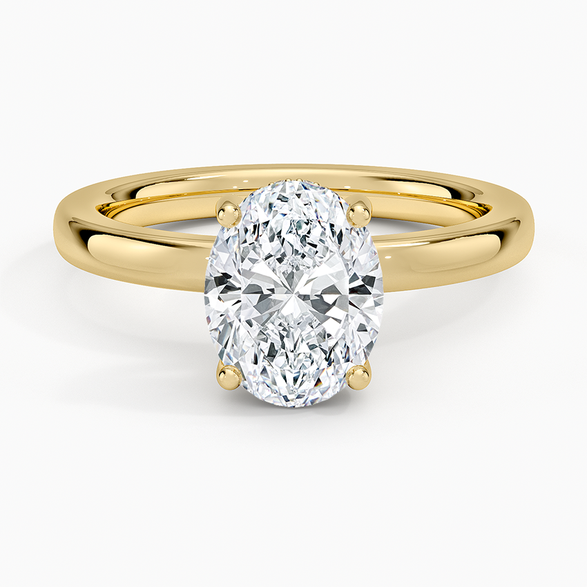 Oval cut lab grown diamond ring with a hidden halo on a rounded comfort fit band in yellow gold, top view