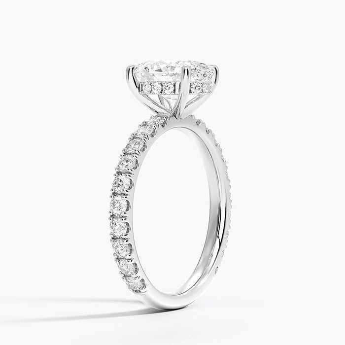 Profile view showing the sharp V of metal cut between each pair of stones and the hidden halo