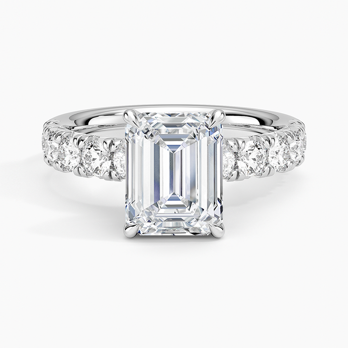 Emerald cut lab grown diamond ring in white gold with large shared prong diamonds along the shoulders, top view