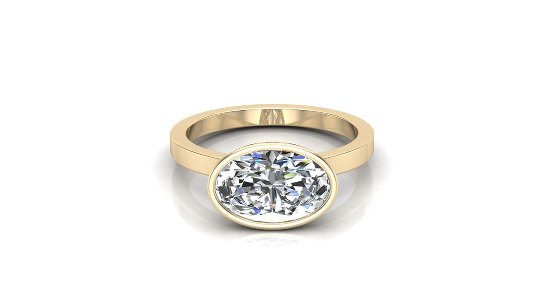 Oval lab grown diamond bezel engagement ring on a flat band