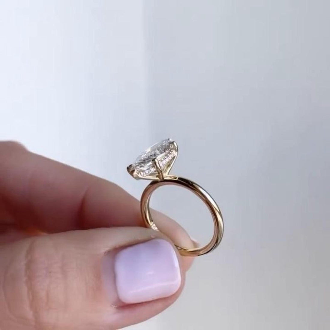 Marquise cut lab grown diamond hidden halo solitaire ring in yellow gold