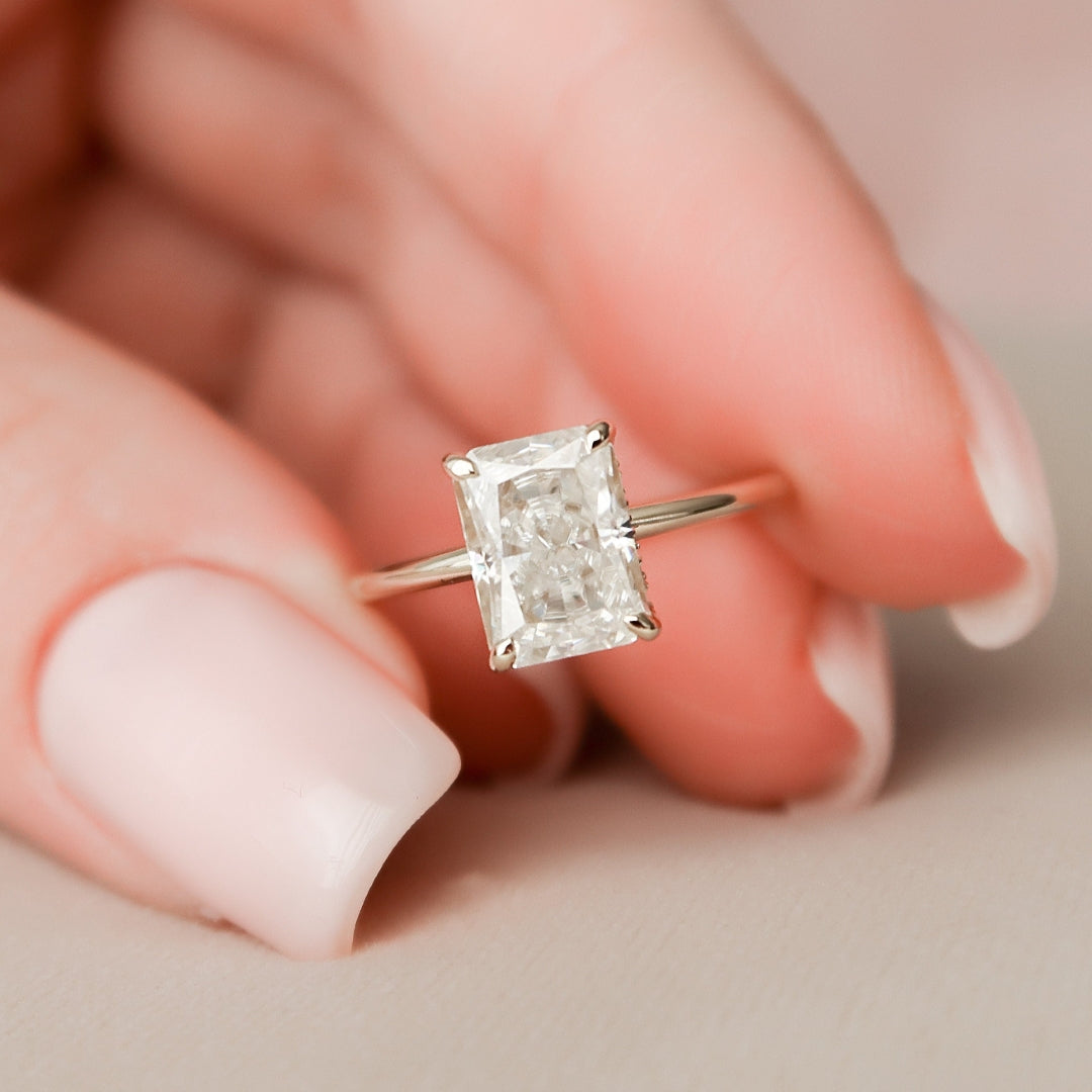 Radiant cut lab grown diamond ring with split claws and a concealed halo