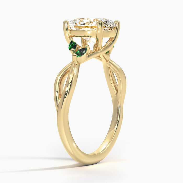 Profile view showing the plain vine looping open at the shoulder with emerald leaves beside the stone