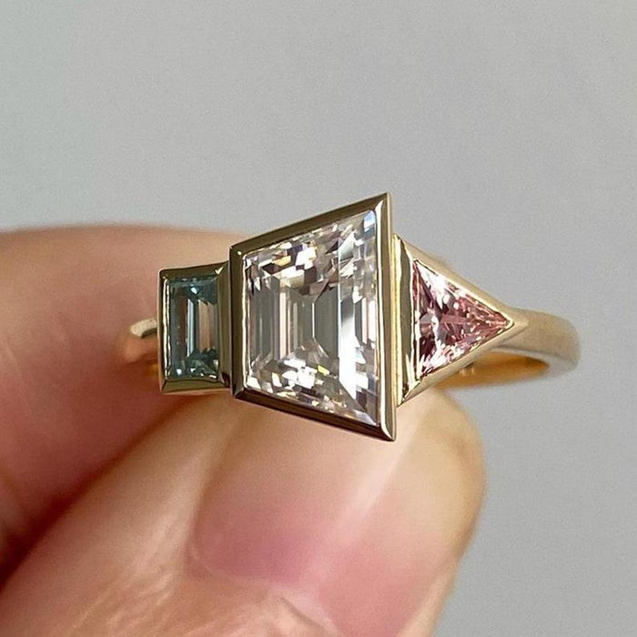 Three trapezoid cut lab grown diamonds set in individual bezels side by side