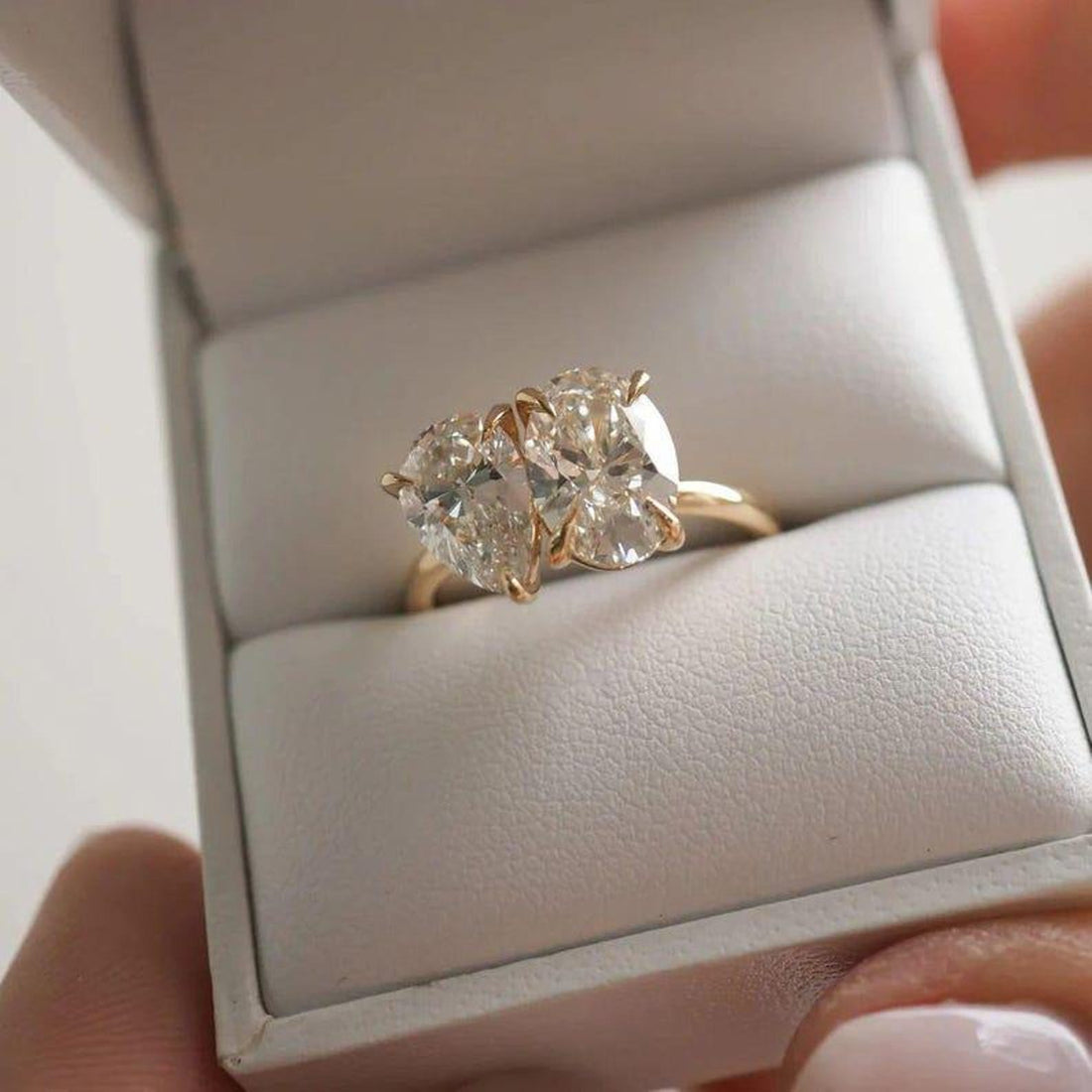 Toi et moi pear and oval cut lab grown diamond engagement ring in yellow gold