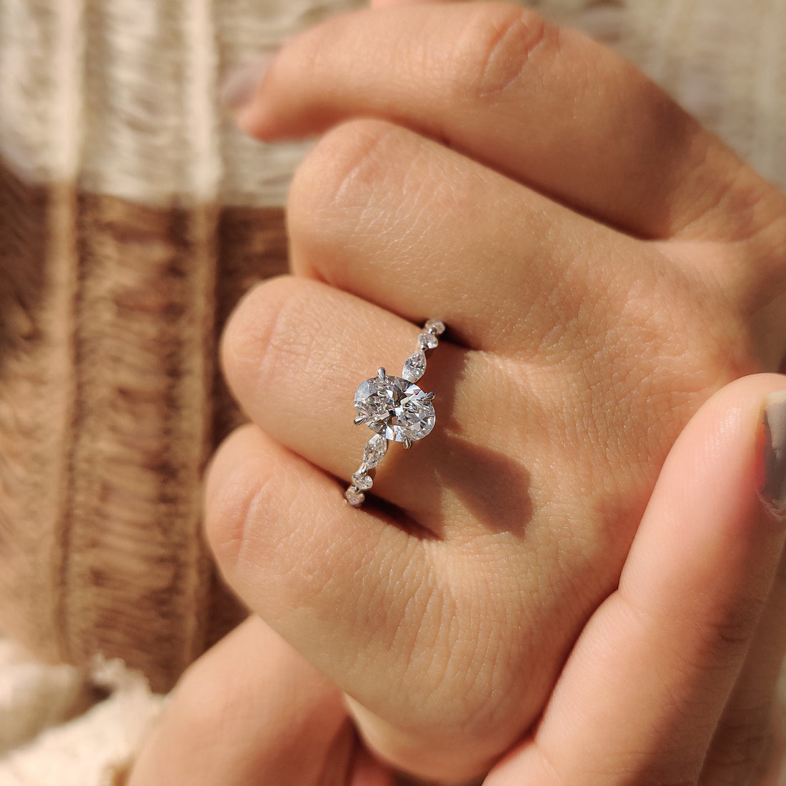 Oval cut lab grown diamond ring with marquise and round pave