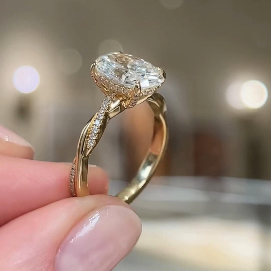Oval cut lab grown diamond engagement ring with hidden halo and twisted pave shank