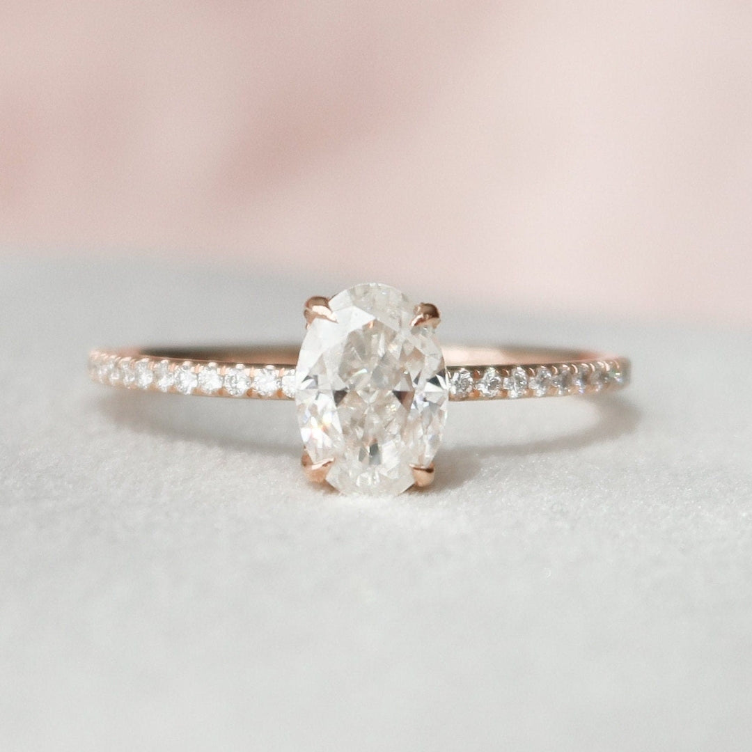 Oval cut lab grown diamond ring on a delicate rose gold pave shank
