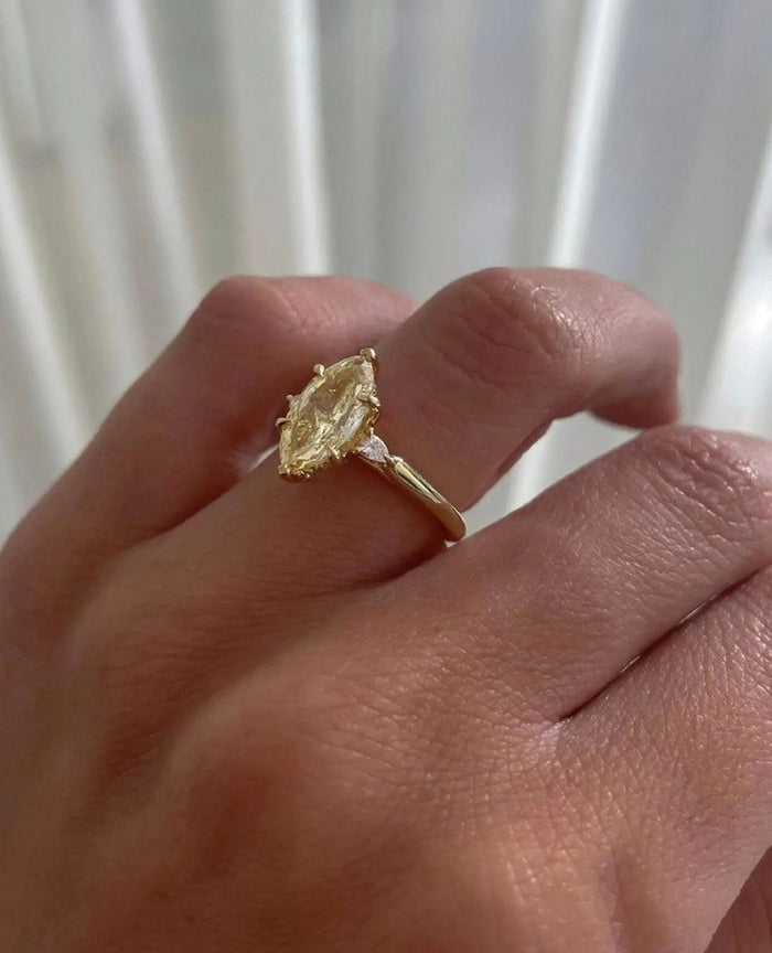 Marquise cut lab grown diamond engagement ring with tapered baguettes in yellow gold