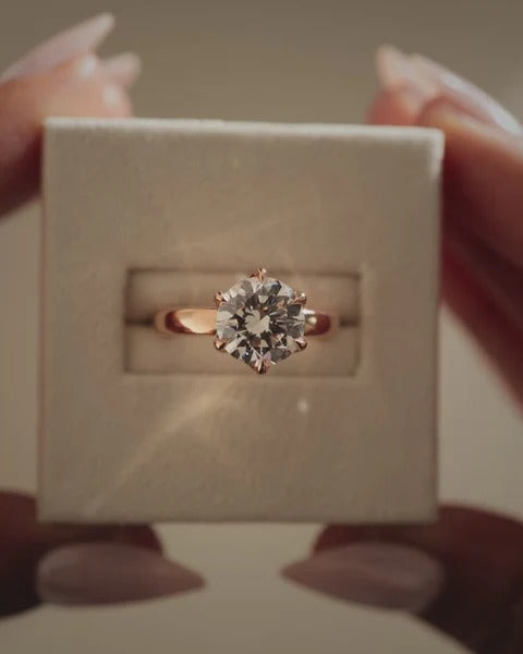 Six claw round diamond solitaire ring with cigar band