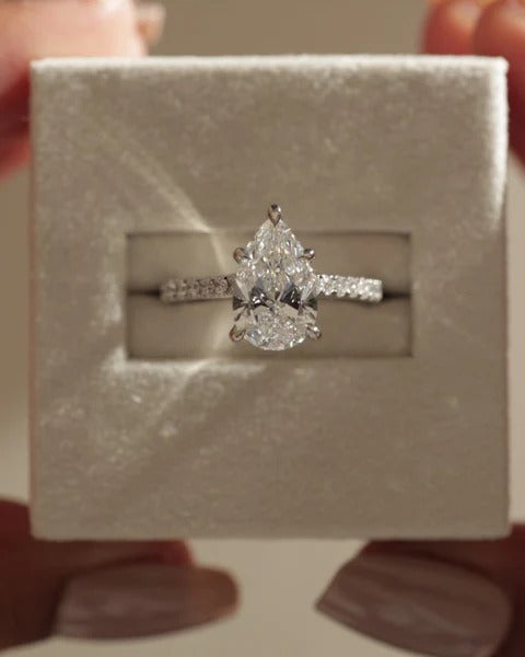Five claw pear cut diamond pave solitaire ring with hidden halo