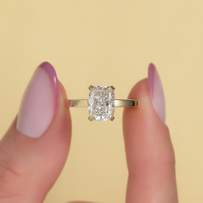 Elongated cushion cut lab grown diamond double claw engagement ring in yellow gold, front view