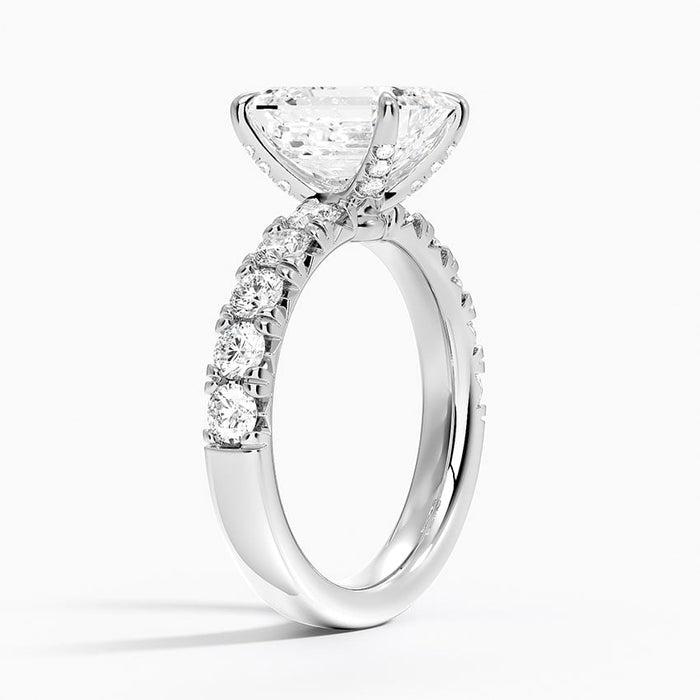 Profile view showing the shared prongs holding each pair of accent diamonds