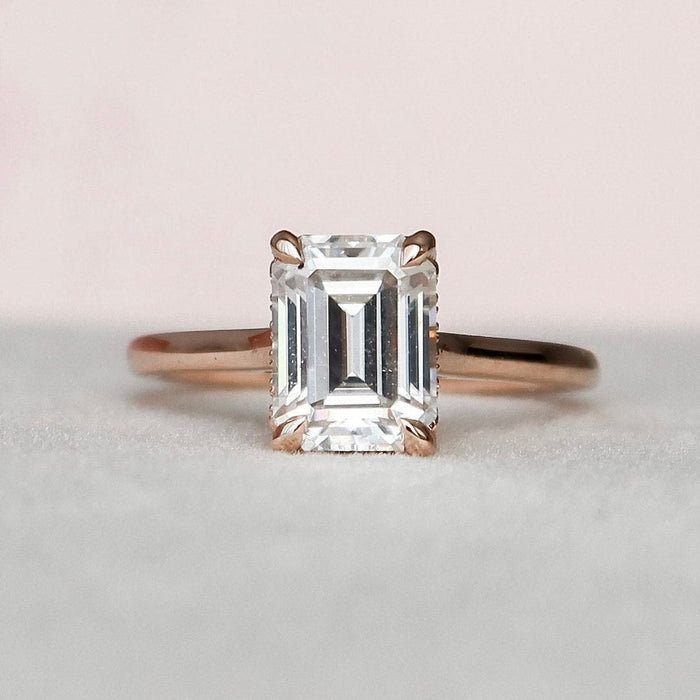 Emerald cut lab grown diamond ring with hidden halo on a plain rose gold band