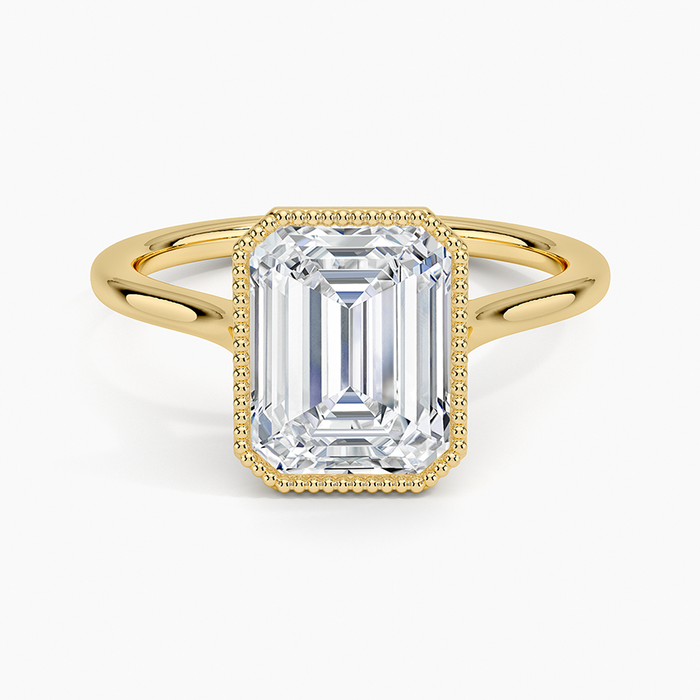 Emerald cut lab grown diamond ring in yellow gold with beaded milgrain bezel, top view