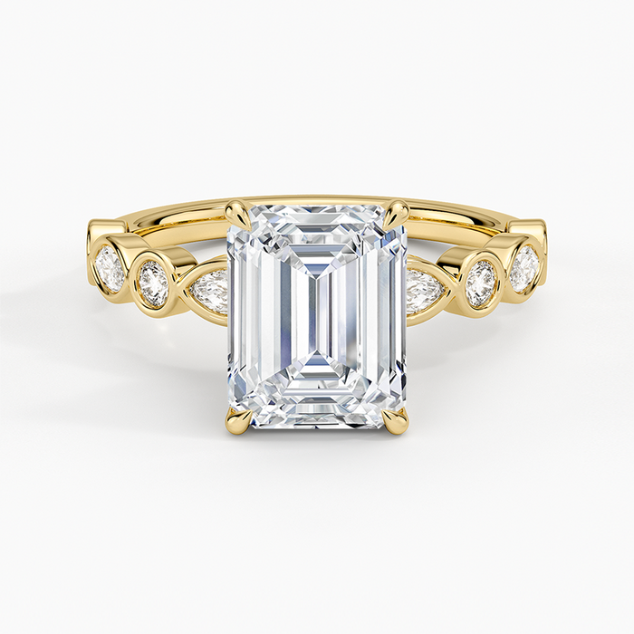 Emerald cut lab grown diamond ring with bezel set marquise and round accent band in yellow gold, top view