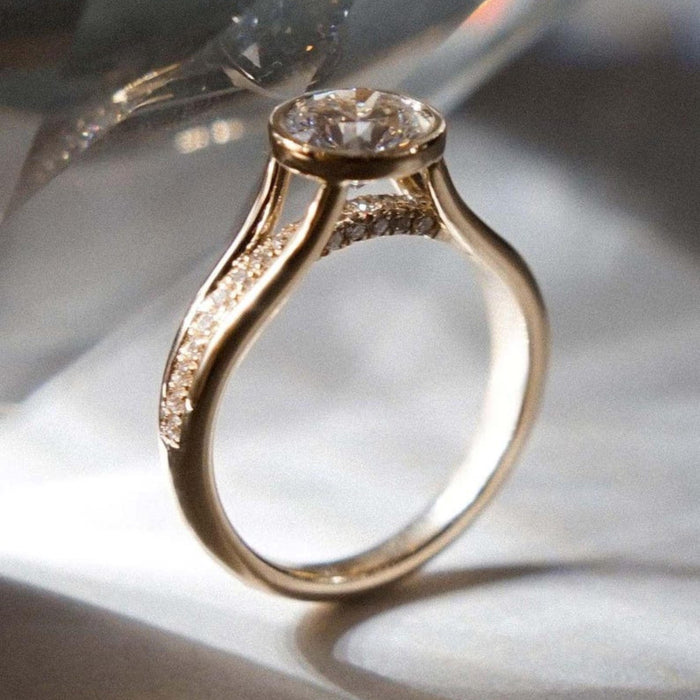 Round cut lab grown diamond bezel set engagement ring with hidden halo and split shank