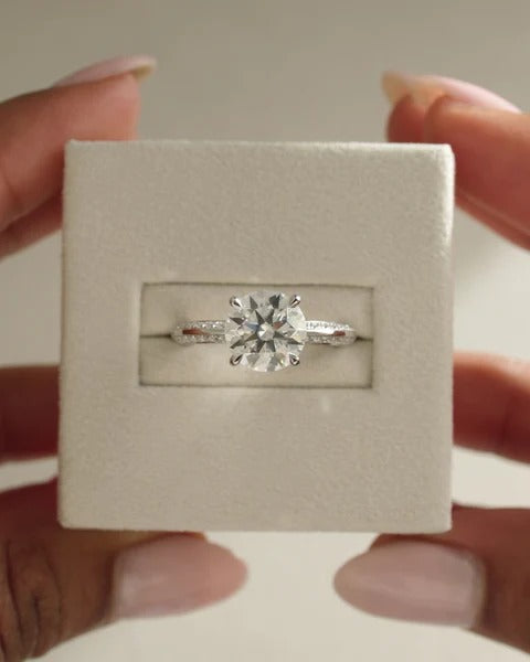 Four claw knife edge round solitaire hidden halo pave engagement ring