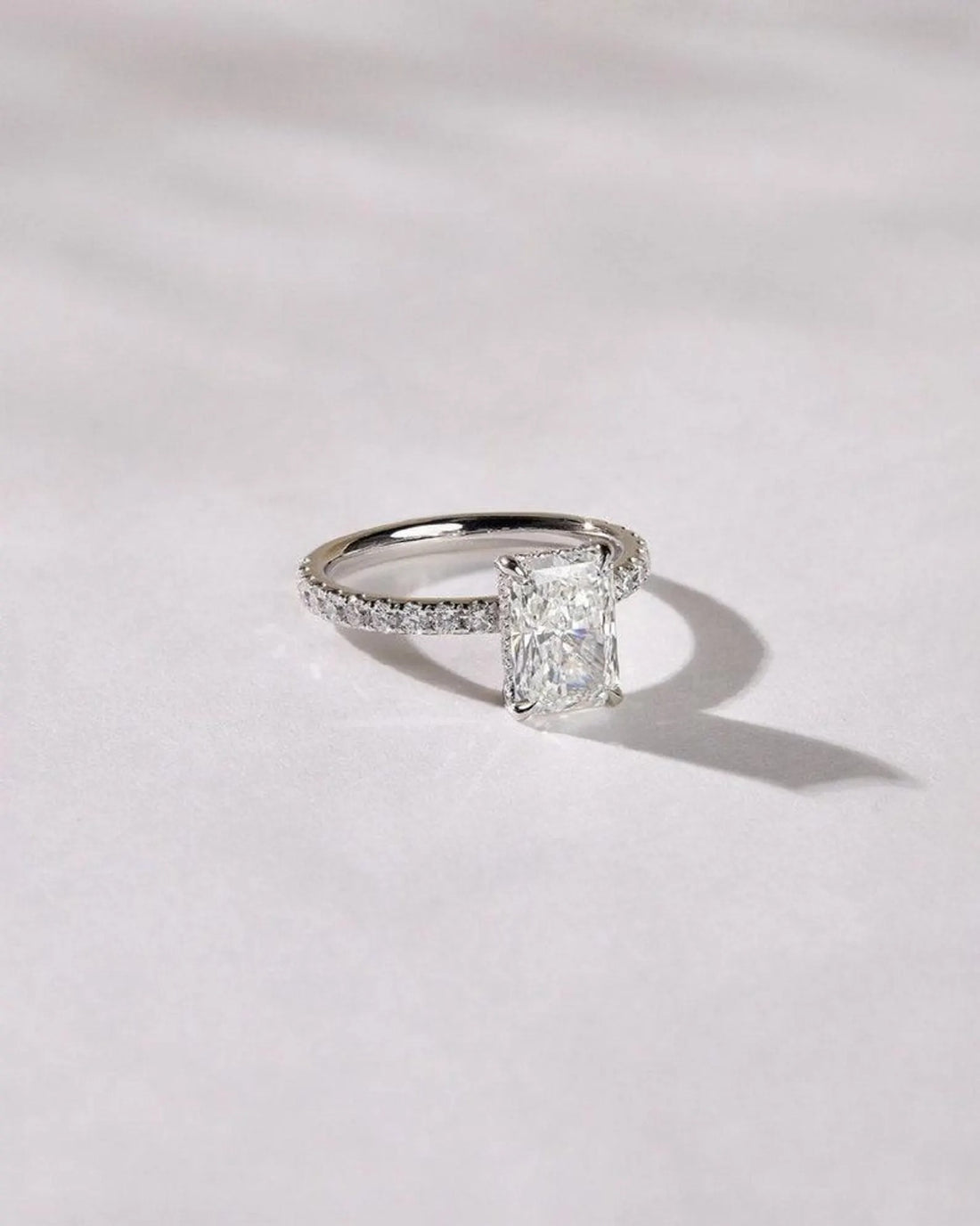Radiant cut lab grown diamond engagement ring with pave band in white gold
