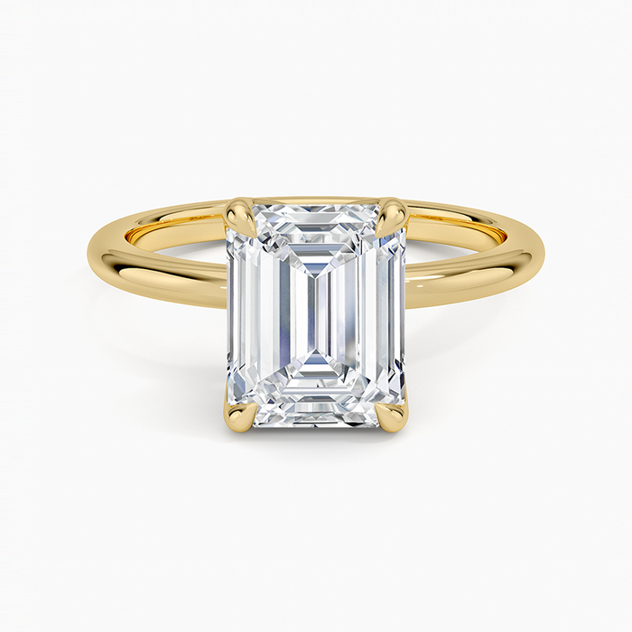 Emerald cut lab grown diamond solitaire ring in yellow gold on a domed comfort fit band, top view