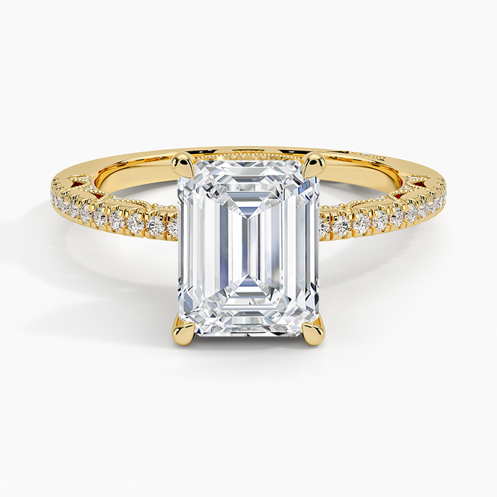 Emerald cut lab grown diamond ring with slim pave band and lace gallery in yellow gold, top view