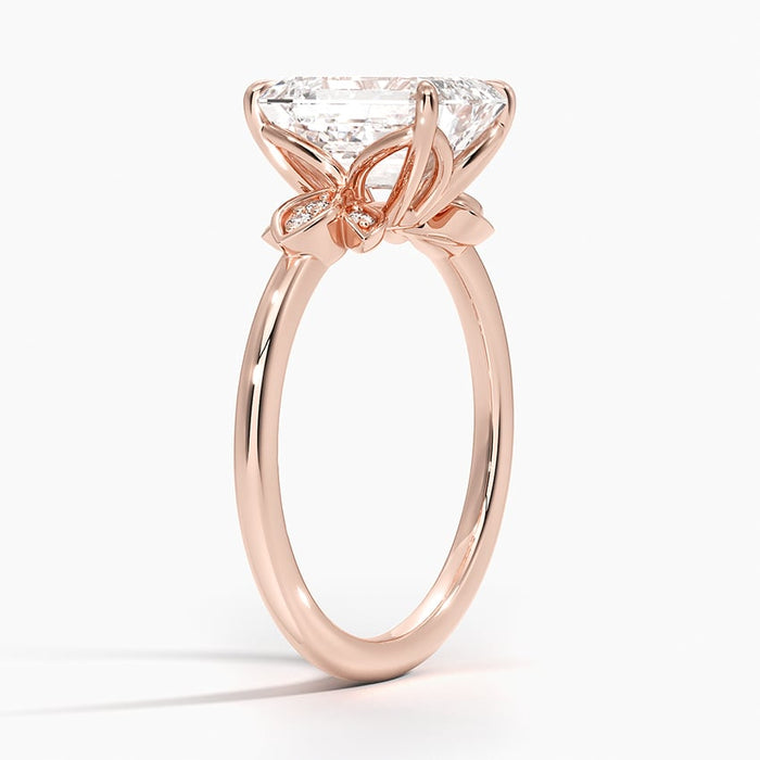 Profile view showing the leaf panels angled away from the emerald cut center stone