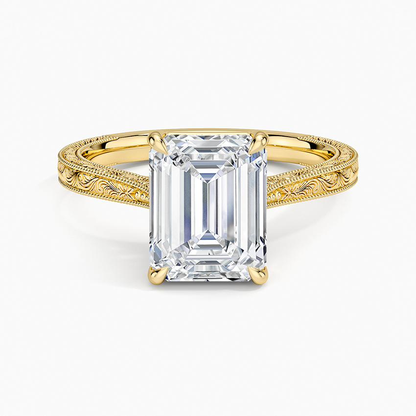Emerald cut lab grown diamond ring in yellow gold on a hand engraved scroll band with milgrain edges, top view