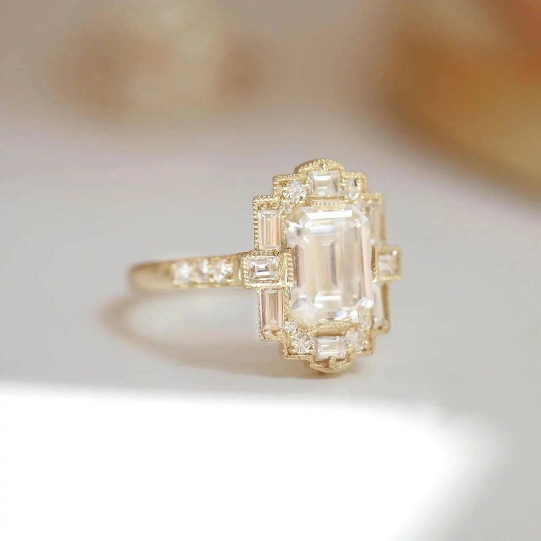 Art Deco emerald cut lab grown diamond engagement ring with stepped halo in yellow gold