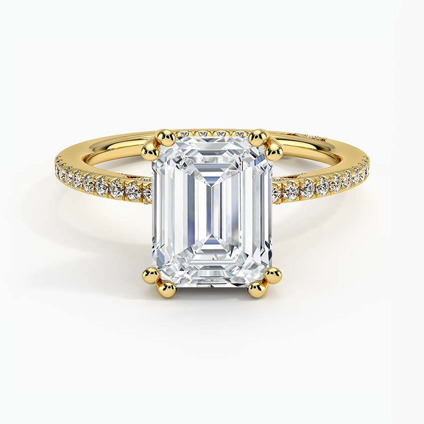 Emerald cut lab grown diamond ring with double ball prongs and pave band in yellow gold, top view