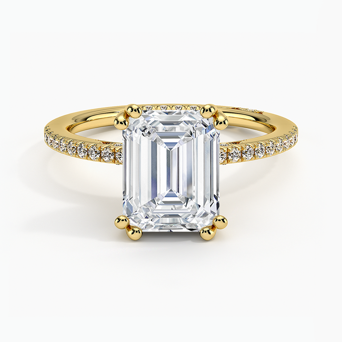 Emerald cut lab grown diamond ring with double ball prongs and pave band in yellow gold, top view