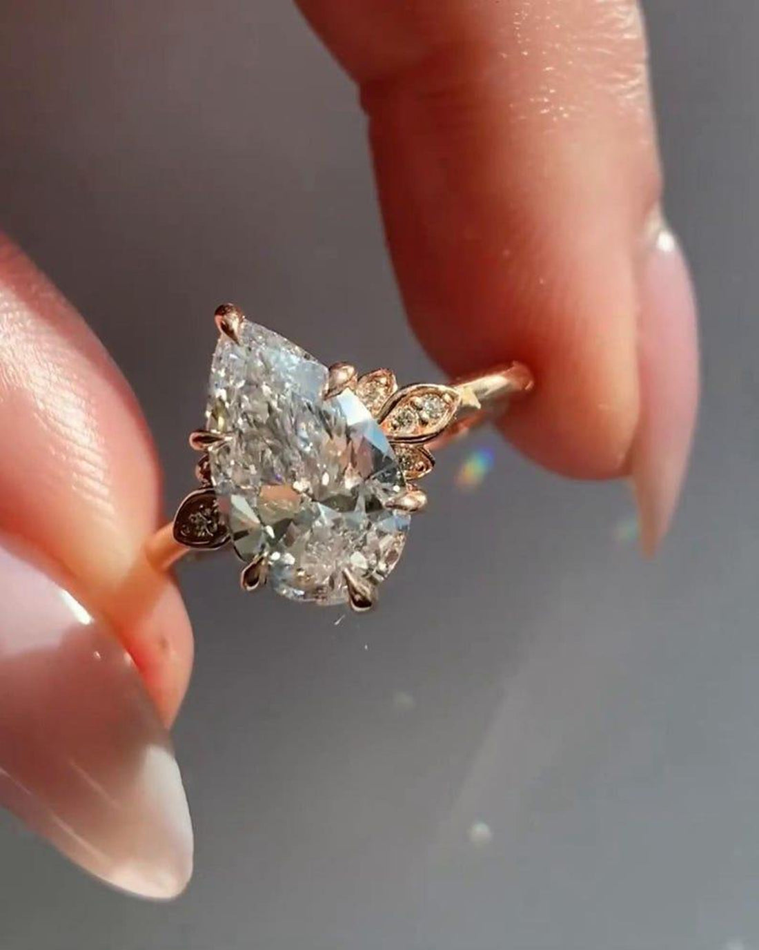 Pear cut lab grown diamond rose gold ring on hand