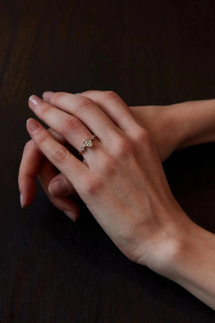Princess cut square accents set at an angle beside the oval centre stone