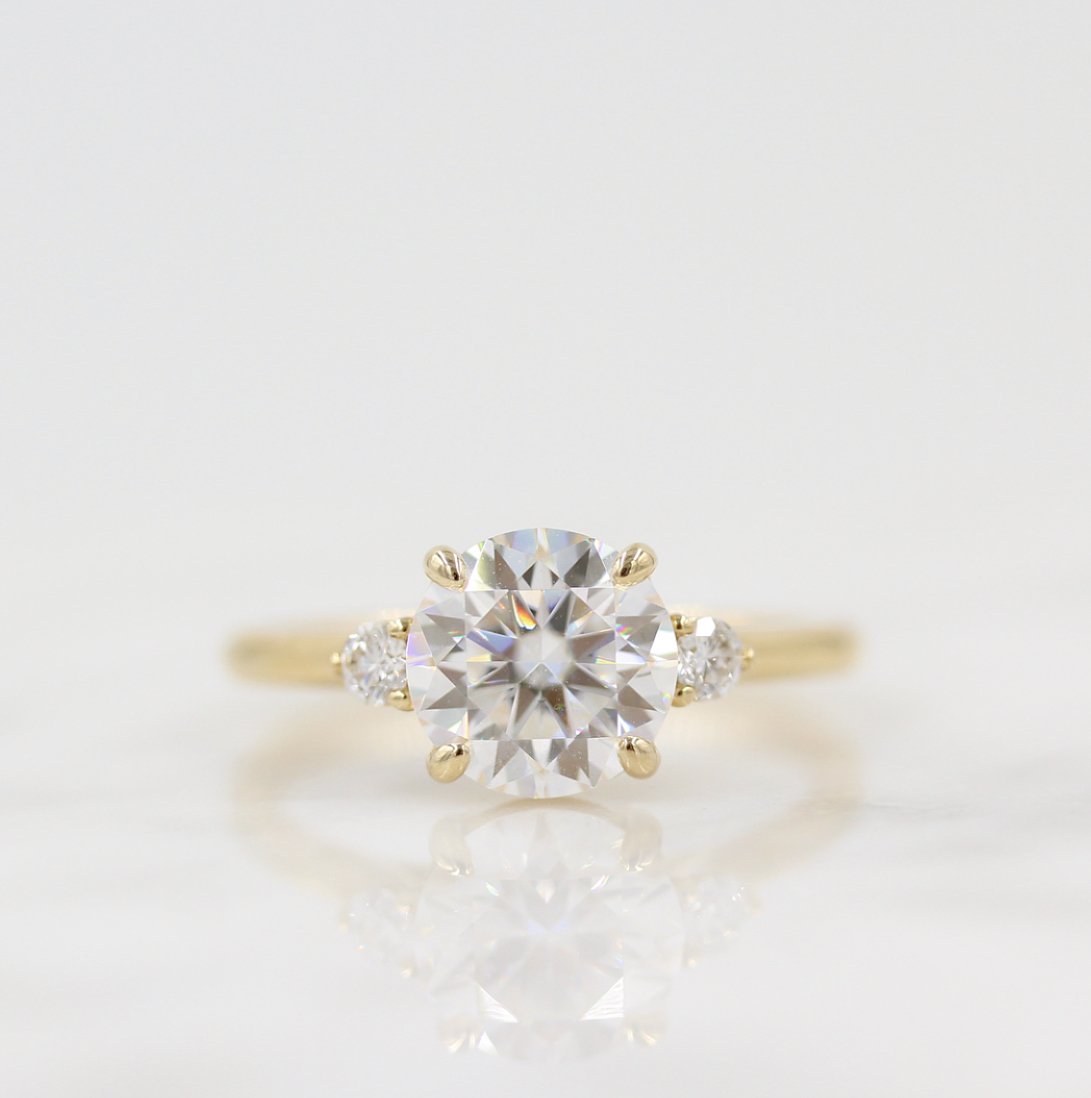 Round lab grown diamond three stone ring with pear side stones
