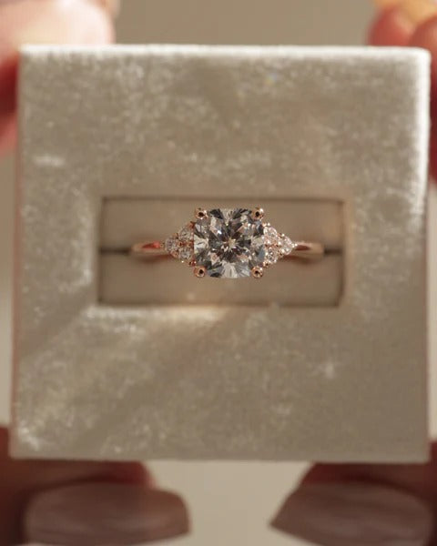 Cushion cut diamond solitaire ring with round accent stones