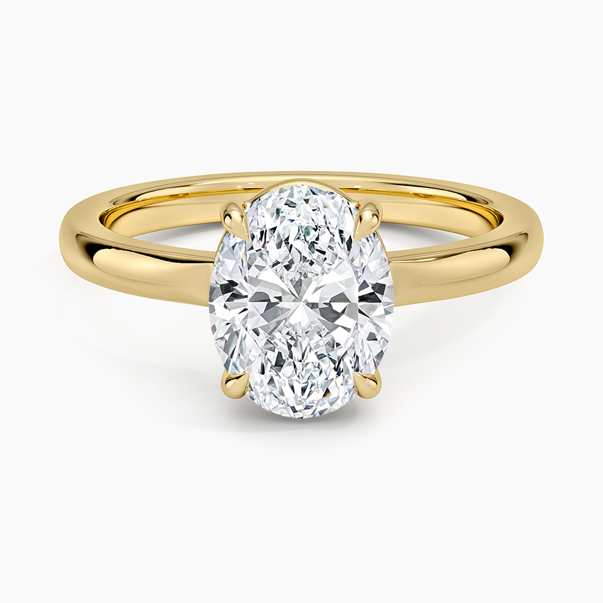 Oval cut lab grown diamond solitaire ring with wide flat tab claws in yellow gold, top view