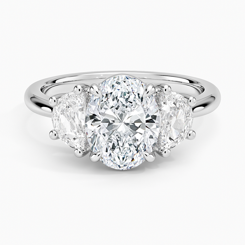 Oval cut lab grown diamond three stone ring with large half moon sides in white gold, top view