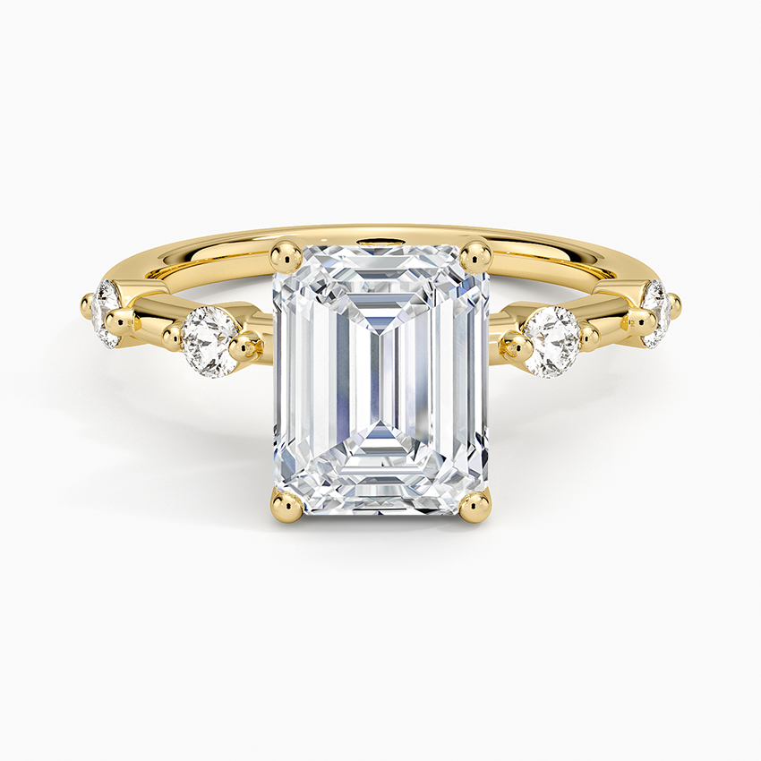 Emerald cut lab grown diamond ring in yellow gold with alternating large and small round accents, top view