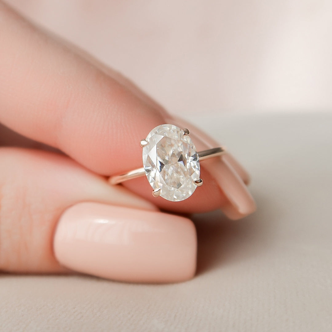 Oval cut lab grown diamond ring with split claws on a fine plain band