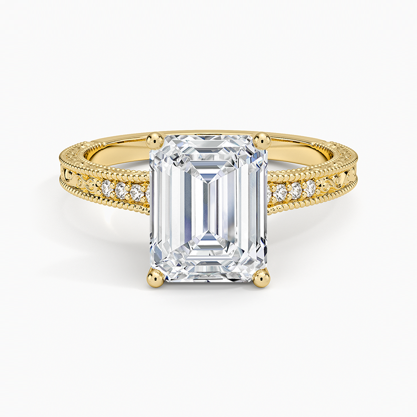 Emerald cut lab grown diamond ring in yellow gold with milgrain edged pave shoulders and engraved sides, top view