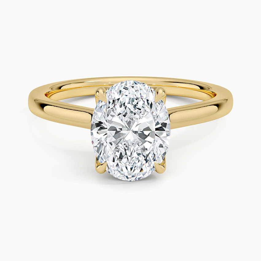 Oval cut lab grown diamond solitaire ring on a plain tapered yellow gold band, top view