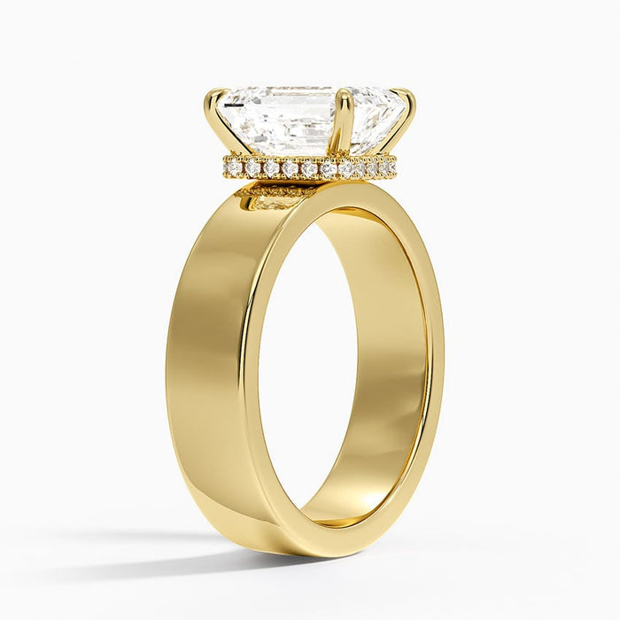 Profile view showing the milgrain edged hidden halo beneath the emerald cut stone