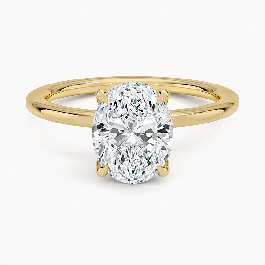 Oval cut lab grown diamond solitaire ring on a fine round wire yellow gold band, top view