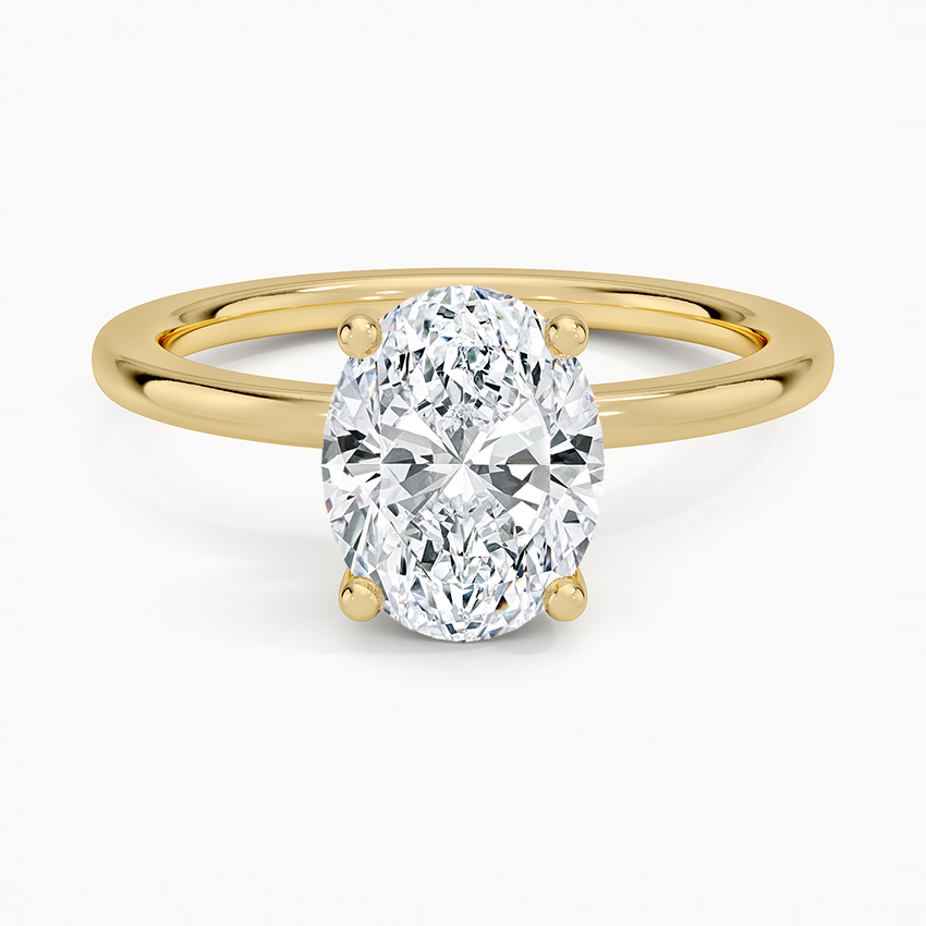 Oval cut lab grown diamond ring with hidden halo on a perfect fit yellow gold band, top view