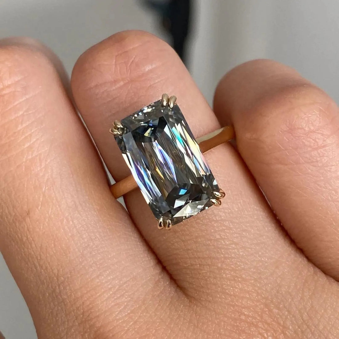 Elongated radiant cut lab grown diamond solitaire engagement ring in yellow gold