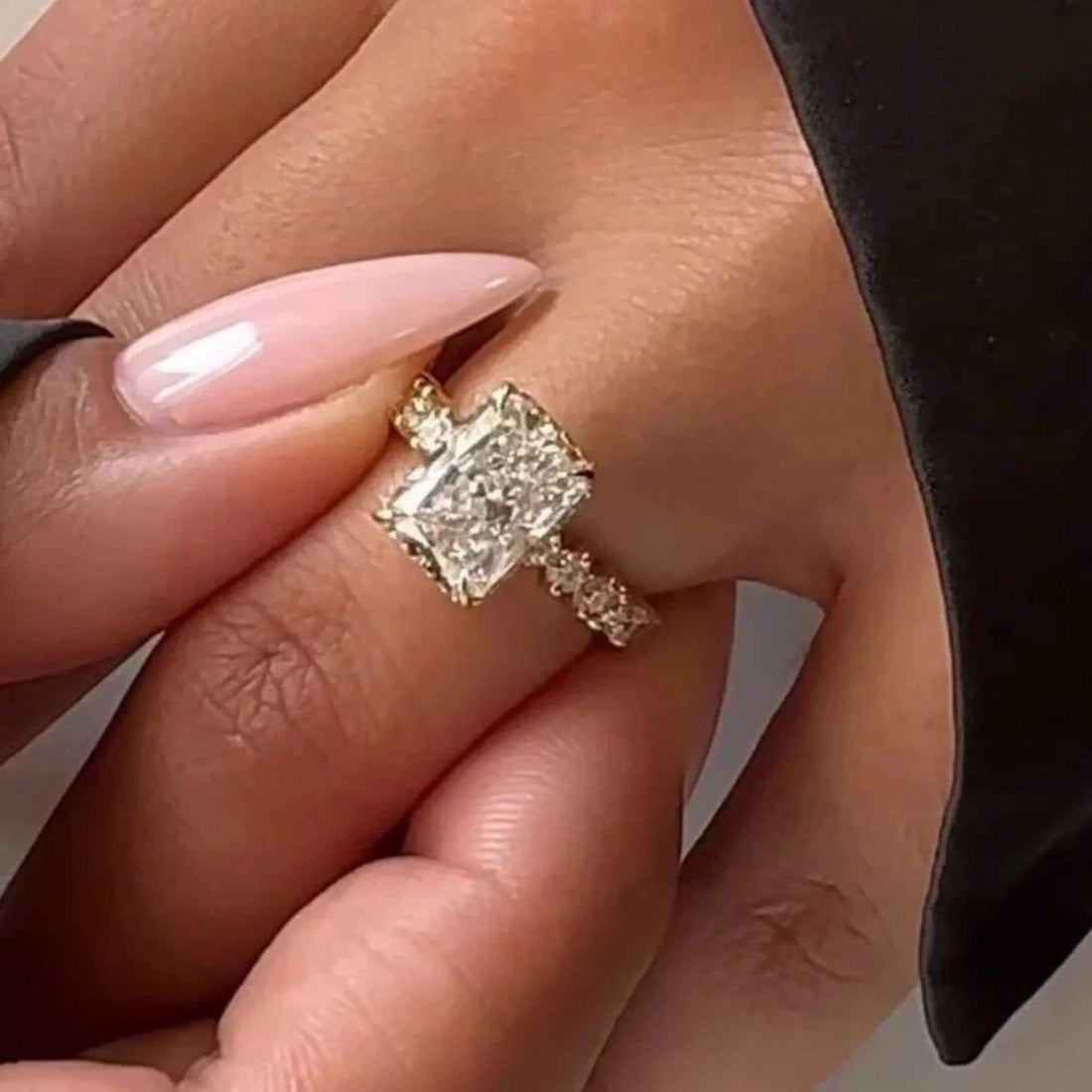 Radiant cut lab grown diamond ring with round and emerald cut accents